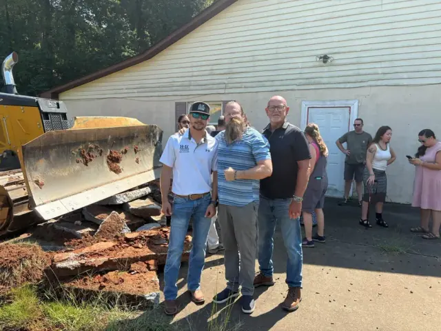 Groundbreaking day at a new mini golf site in Rutherfordton, with an H&L dozer behind