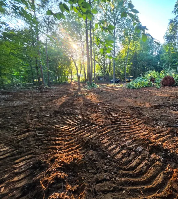 Graded red-clay house site cleared of trees by the H&L grading crew