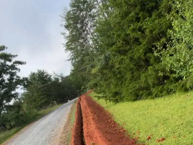 Water line trench dug along a rural road