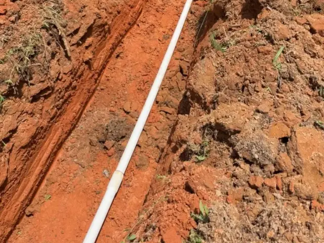 Pipe laid in a red-clay trench for a 1700 foot water line
