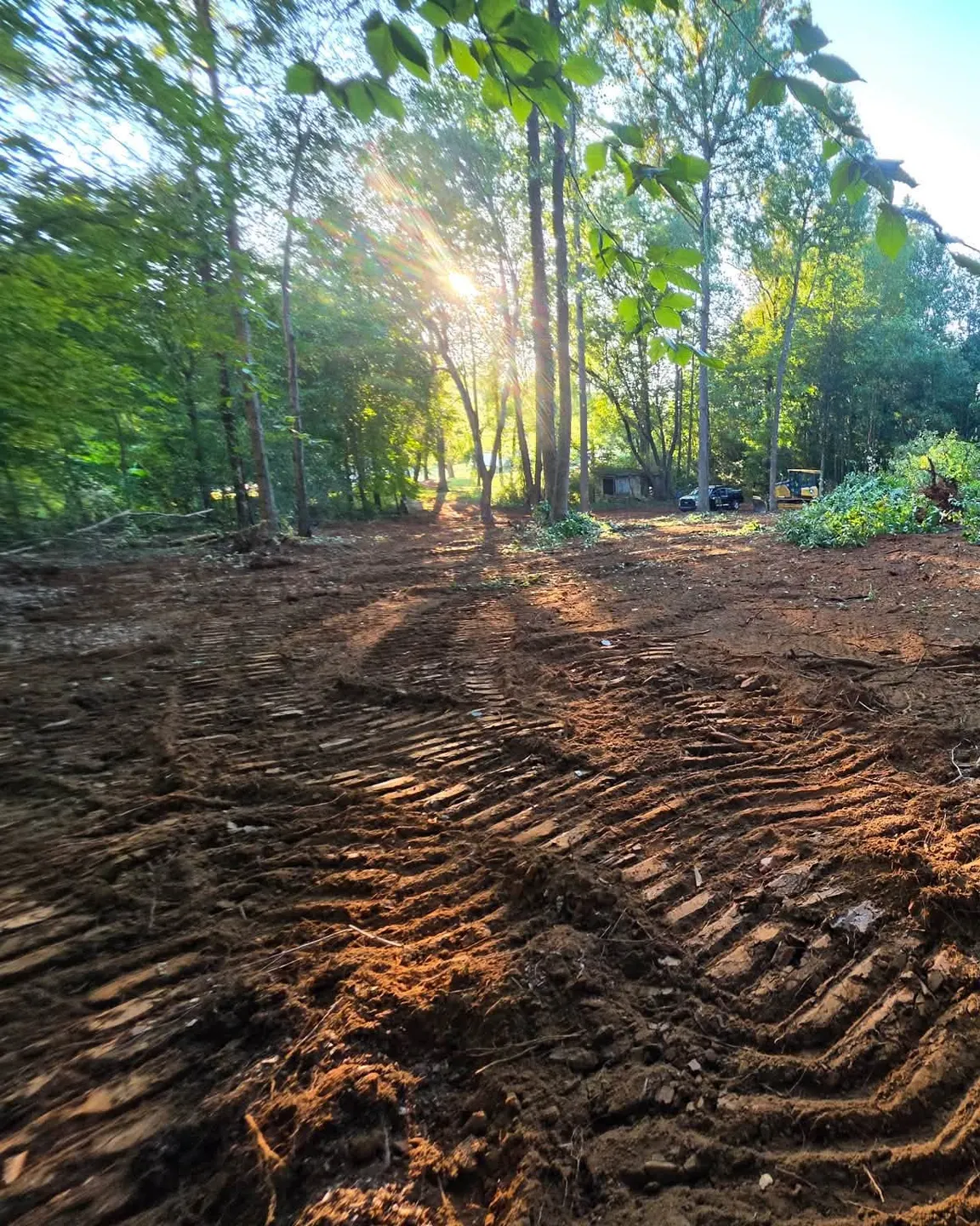 Graded red-clay house site cleared of trees by the H&L grading crew