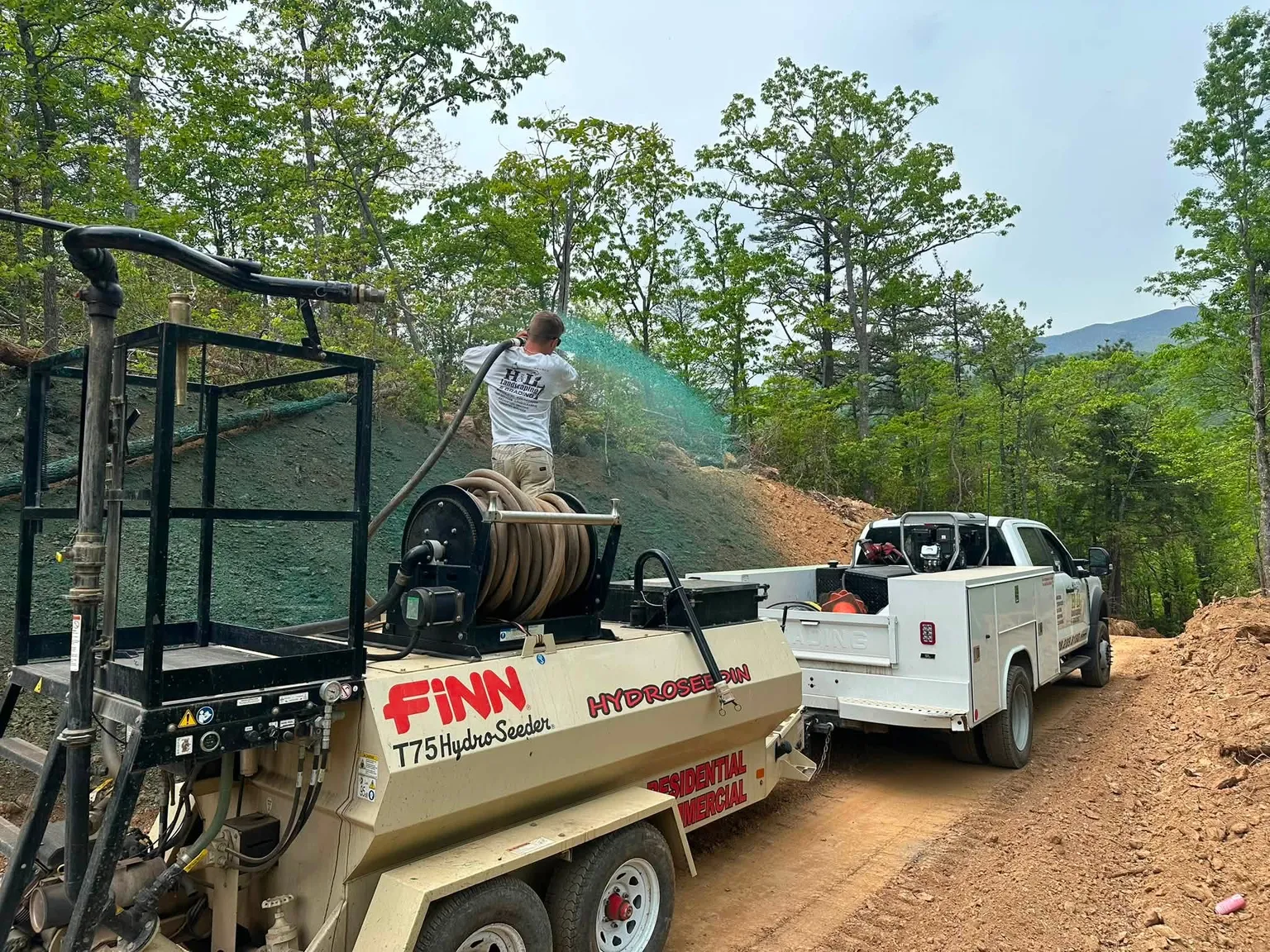 H&L crew member spraying hydroseed from a truck-mounted hydroseeder