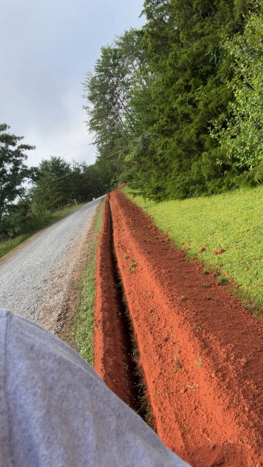Trench dug along a rural road for a 1,700 foot water line